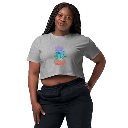 Woman in a grey crop top with a colorful cosmic design expressing artistic individuality