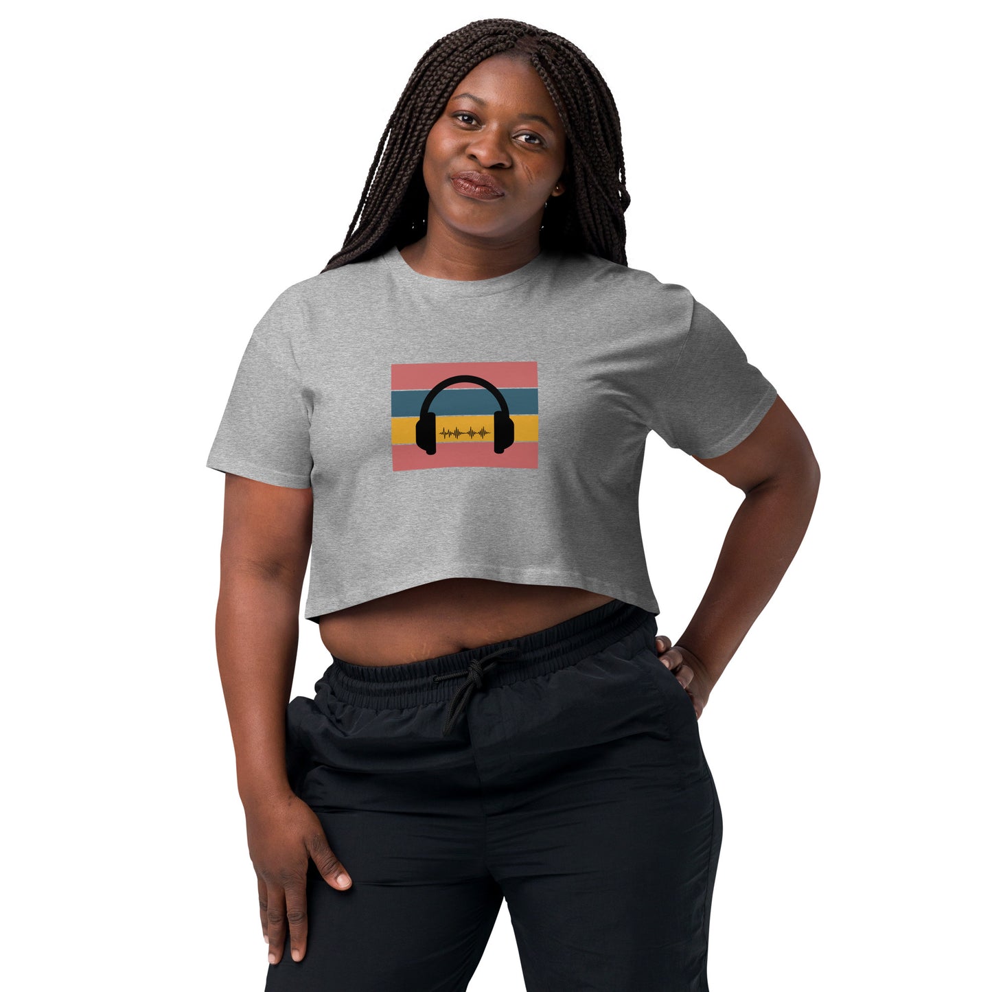 Confident woman wearing a grey crop top with colorful headphone graphic design.