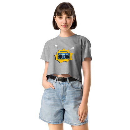 Woman in grey crop top featuring a quirky camera graphic with playful accents