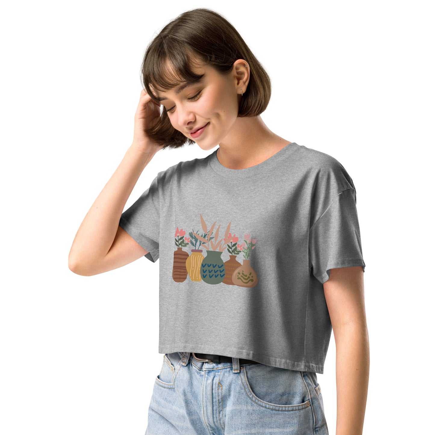 Woman wearing a athletic grey loose-fit crop top with a charming vase floral graphic design, embodying comfortable and authentic fashion by BYOL.