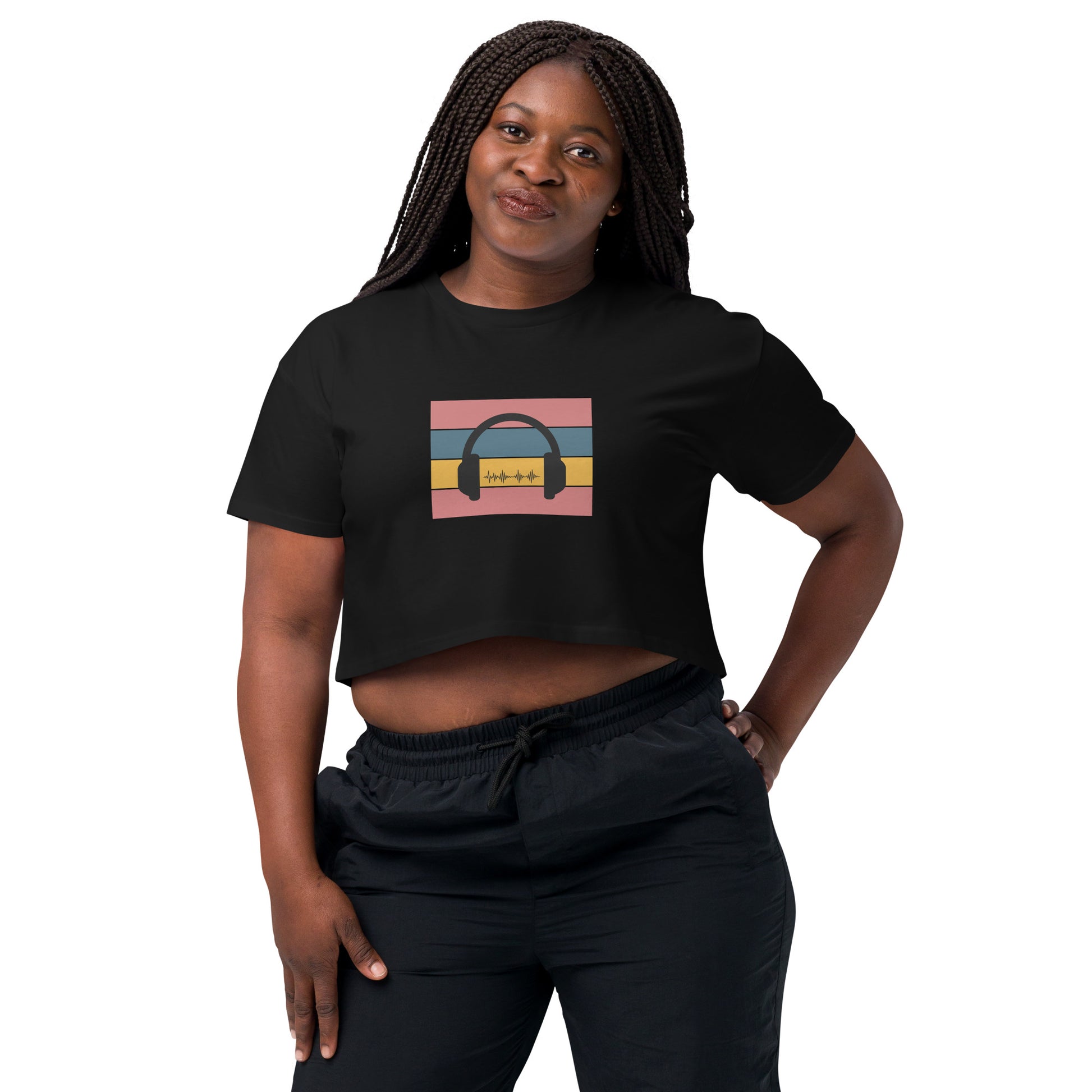 Confident woman wearing a black crop top with colorful headphone graphic design.