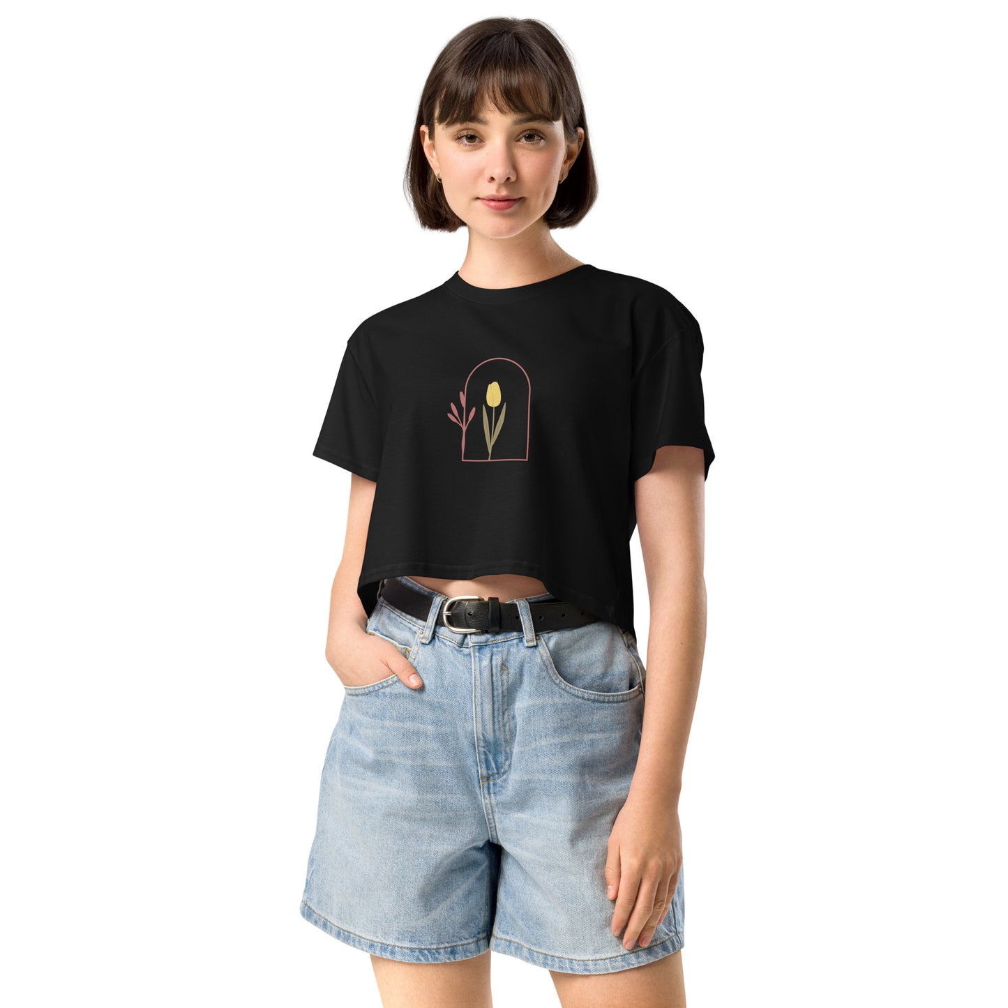 Woman wearing a black loose-fit crop top with a delicate floral window graphic design, representing comfortable and authentic fashion by BYOL.