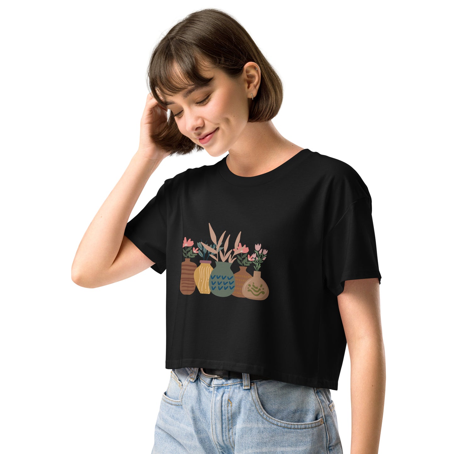 Woman wearing a black loose-fit crop top with a charming vase floral graphic design, embodying comfortable and authentic fashion by BYOL.