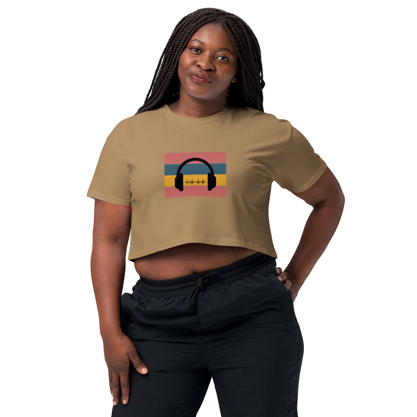 Confident woman wearing a camel crop top with colorful headphone graphic design.