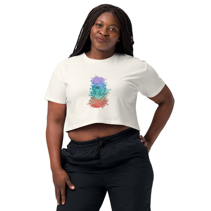 Woman in a ecru crop top with a colorful cosmic design expressing artistic individuality