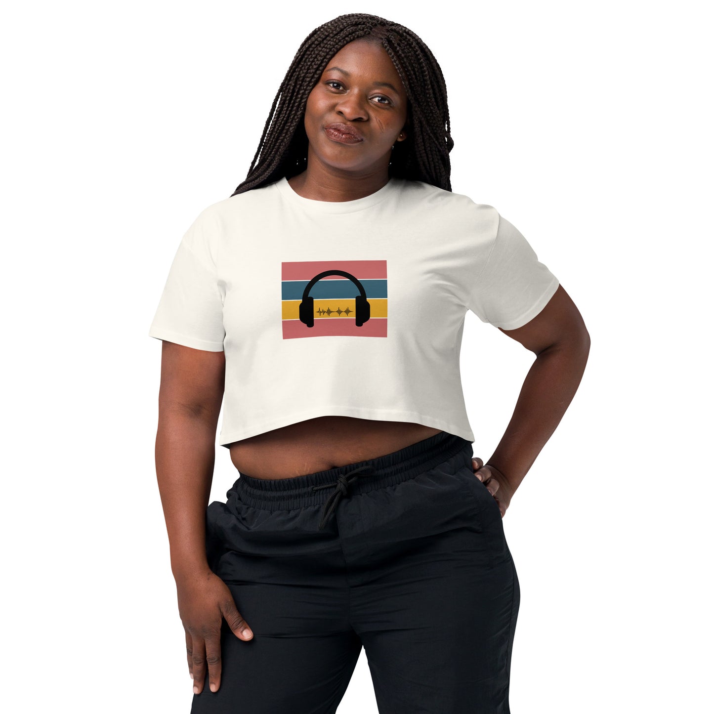 Confident woman wearing a ecru crop top with colorful headphone graphic design.