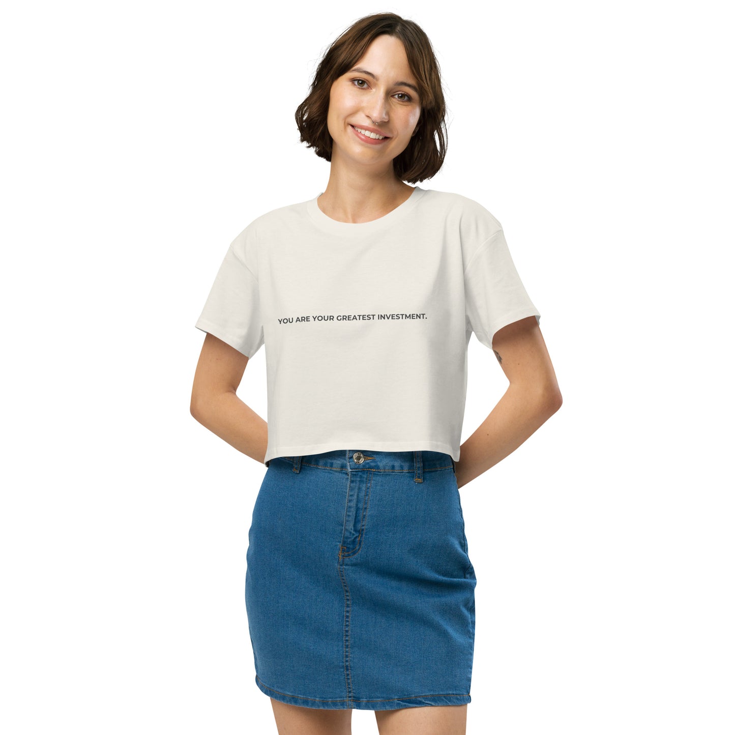 Women’s ecru Loose-Fit Crop Top with "You are your greatest investment" slogan in various colors and sizes, XS to XL.