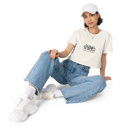 Woman wearing a ecru loose-fit crop top with a subtle cactus graphic design, embodying comfortable and authentic fashion by BYOL.