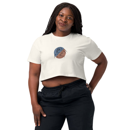 Woman wearing a ecru loose-fit crop top with a minimalist portrait graphic design, embodying comfortable and authentic fashion by BYOL.