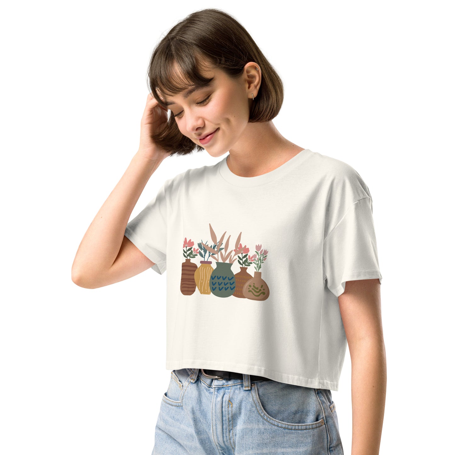 Woman wearing a ecru loose-fit crop top with a charming vase floral graphic design, embodying comfortable and authentic fashion by BYOL.