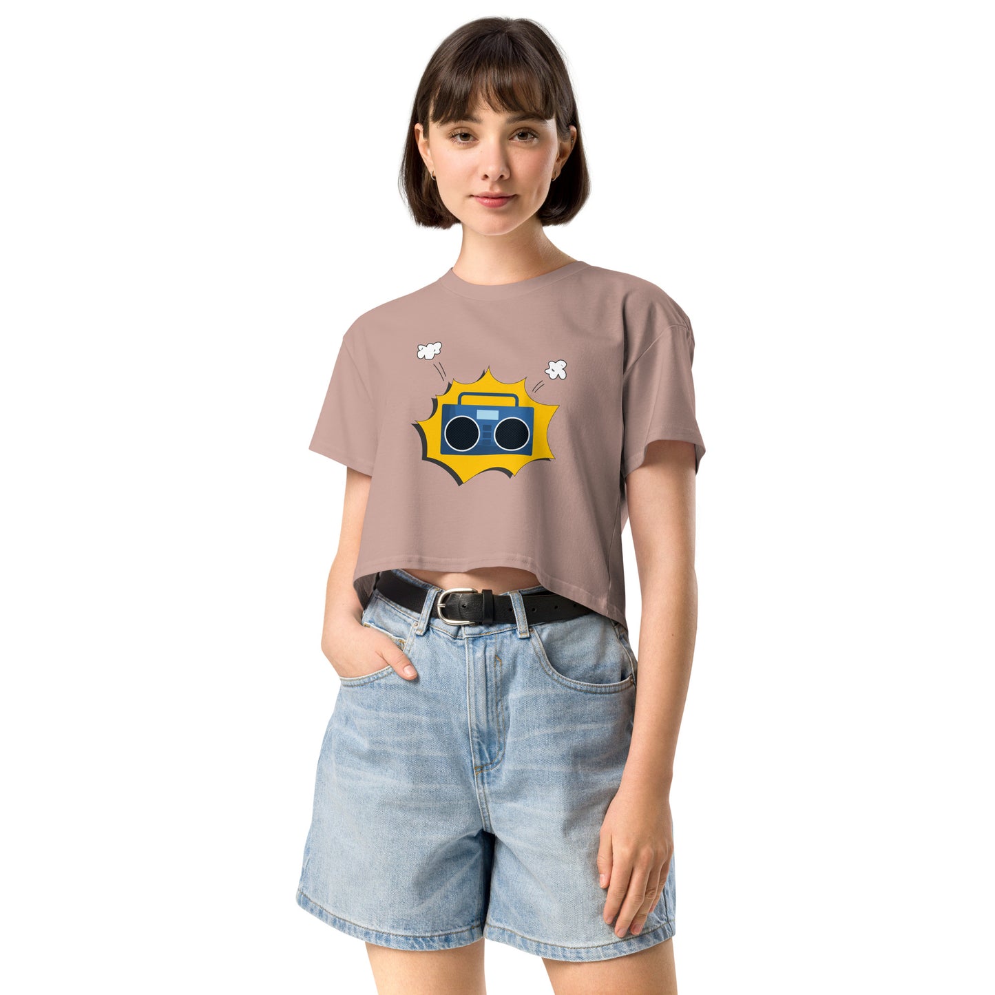 Woman in hazy pink crop top featuring a quirky camera graphic with playful accents