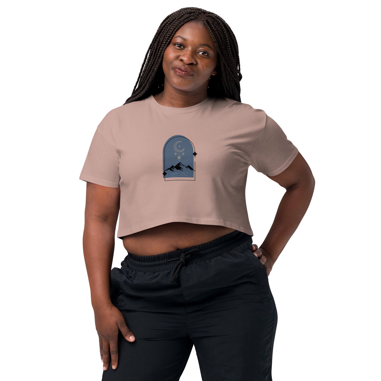 Woman wearing a hazy pink loose-fit crop top with a tranquil night sky graphic design, representing comfortable and authentic fashion by BYOL.