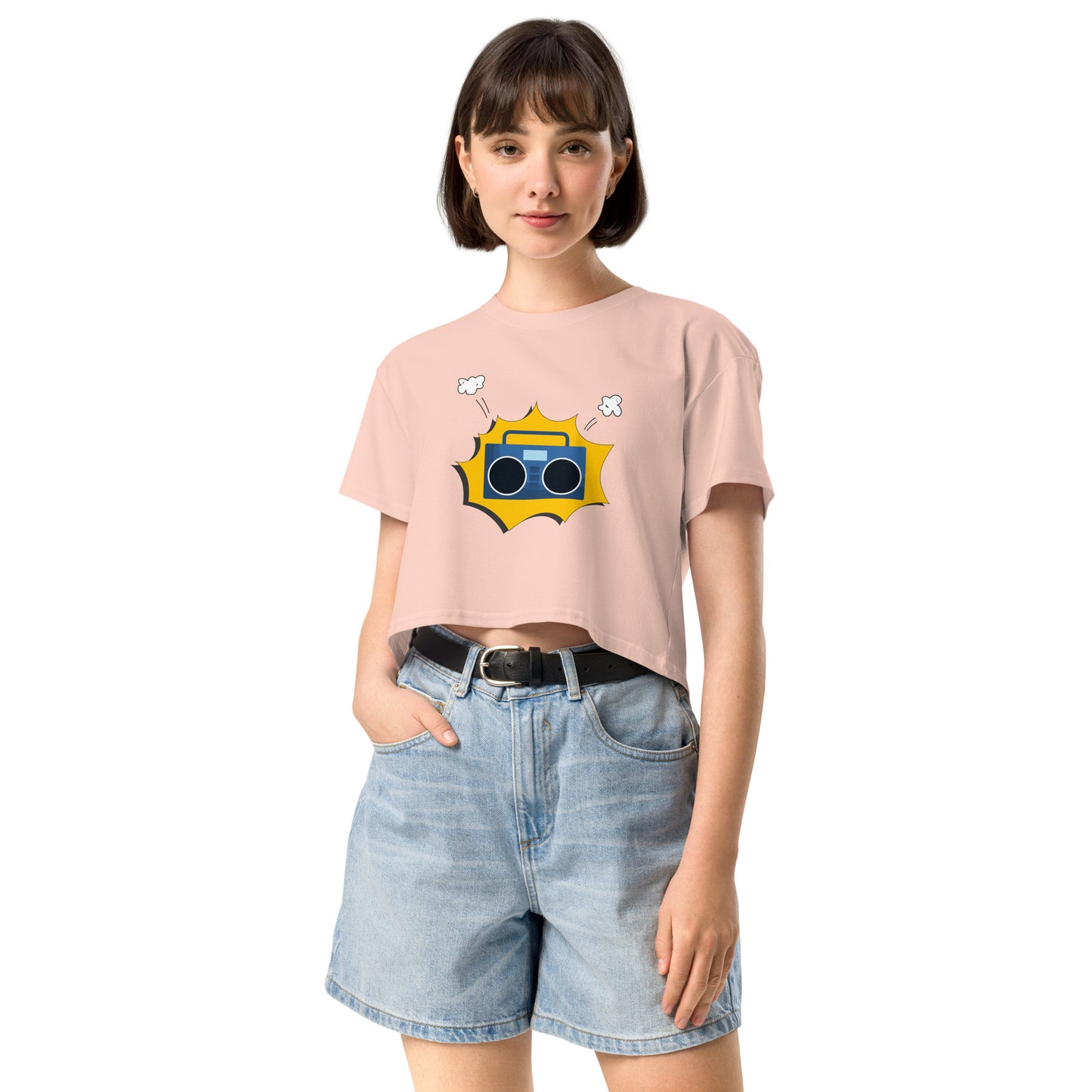 Woman in pale pink crop top featuring a quirky camera graphic with playful accents