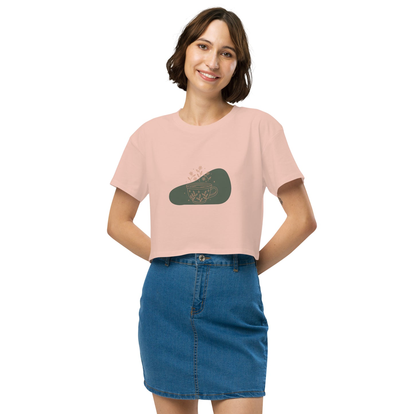 Woman wearing a pale pink loose-fit crop top with a floral coffee cup graphic design, embodying comfortable and authentic fashion by BYOL.