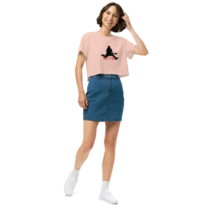 Woman in a pale pink loose-fit crop top with a Rock N’ Roll graphic