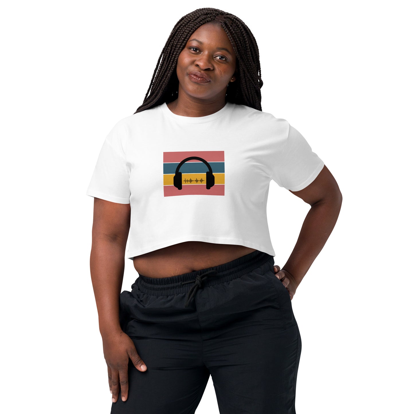 Confident woman wearing a white crop top with colorful headphone graphic design.