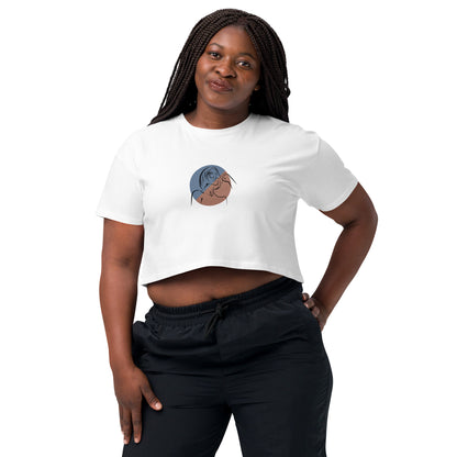 Woman wearing a white loose-fit crop top with a minimalist portrait graphic design, embodying comfortable and authentic fashion by BYOL.