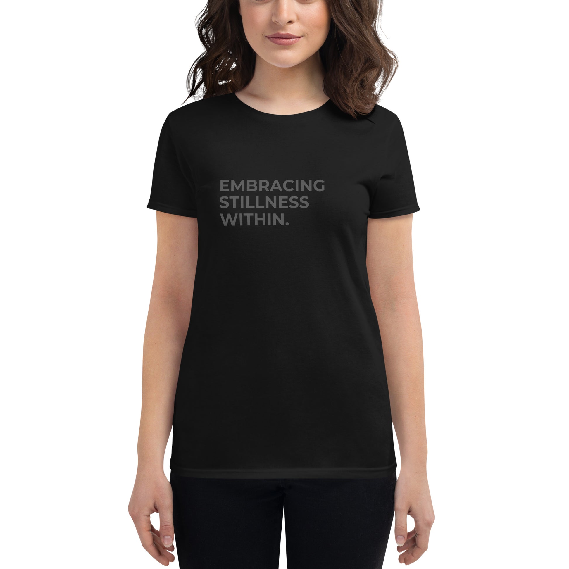 Women’s fitted black tee with the text "Embracing Stillness Within".