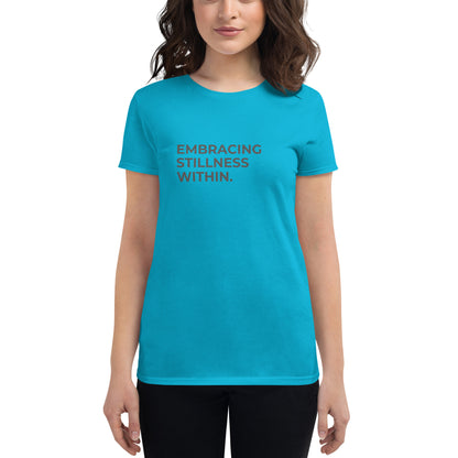 Women’s fitted caribbean blue tee with the text "Embracing Stillness Within".