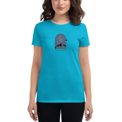 Woman wearing a Caribbean blue fitted tee with a moonlit mountain design, showcasing serene and comfortable fashion by BYOL.