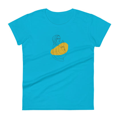 Woman wearing a caribbean blue fitted tee with an empowered silhouette design in yellow, showcasing subtle yet impactful self-expression by BYOL.