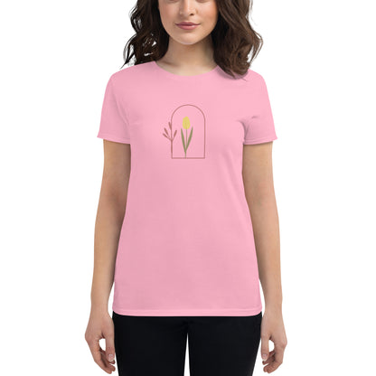 Woman wearing a charity pink fitted tee with a delicate tulip arch design, showcasing subtle elegance and nature-inspired style by BYOL.