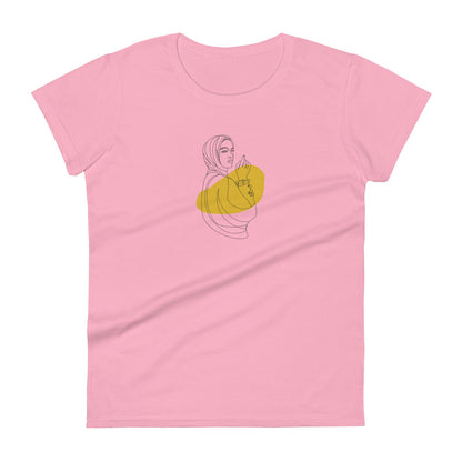 Woman wearing a charity pink fitted tee with an empowered silhouette design in yellow, showcasing subtle yet impactful self-expression by BYOL.