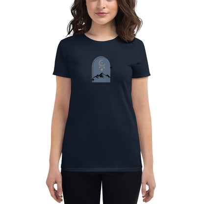 Woman wearing a navy fitted tee with a moonlit mountain design, showcasing serene and comfortable fashion by BYOL.