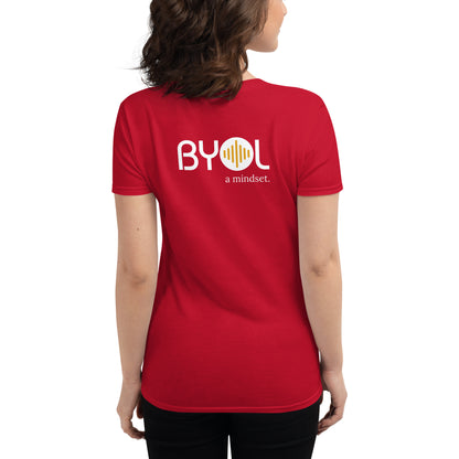 Back view of a woman wearing a red BYOL mindset t-shirt with color options in black, red, blue, gray, and white, available in sizes S to 3XL.