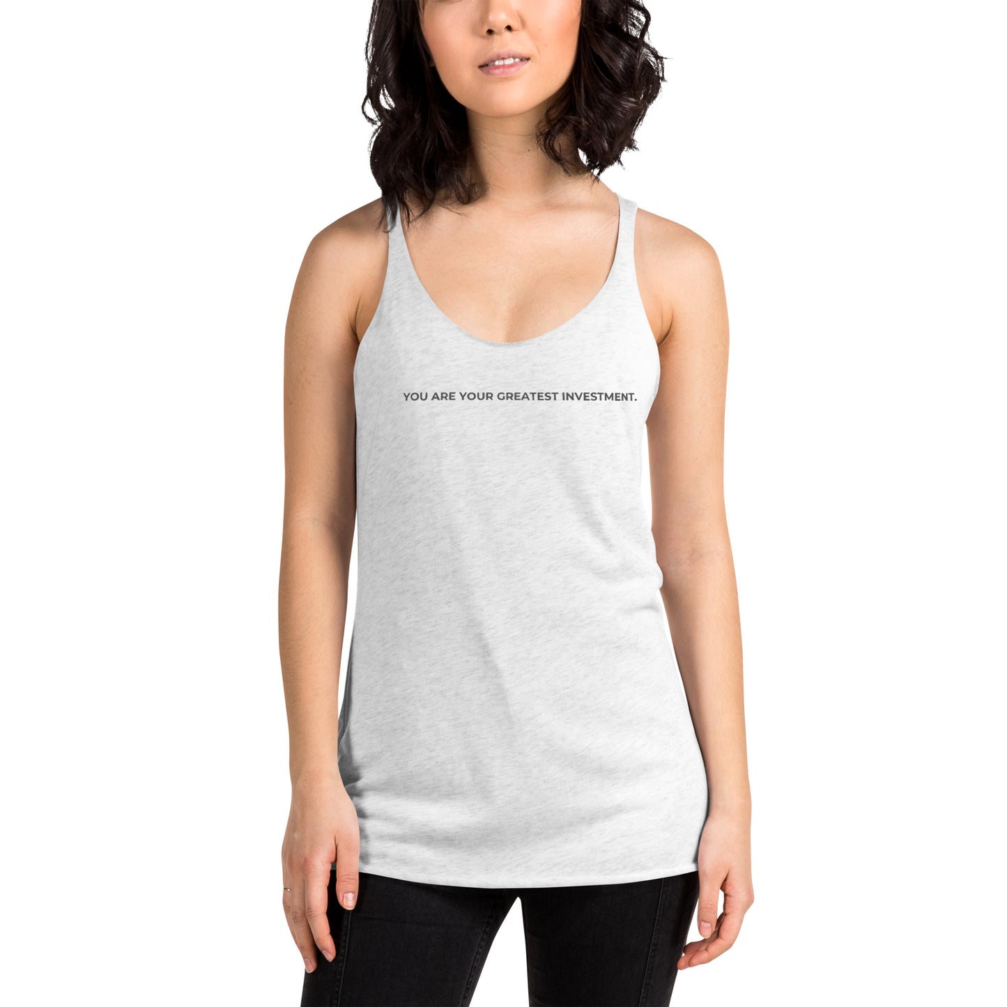 Woman wearing a heather white racer back tank with "You Are Your Greatest Investment" text.