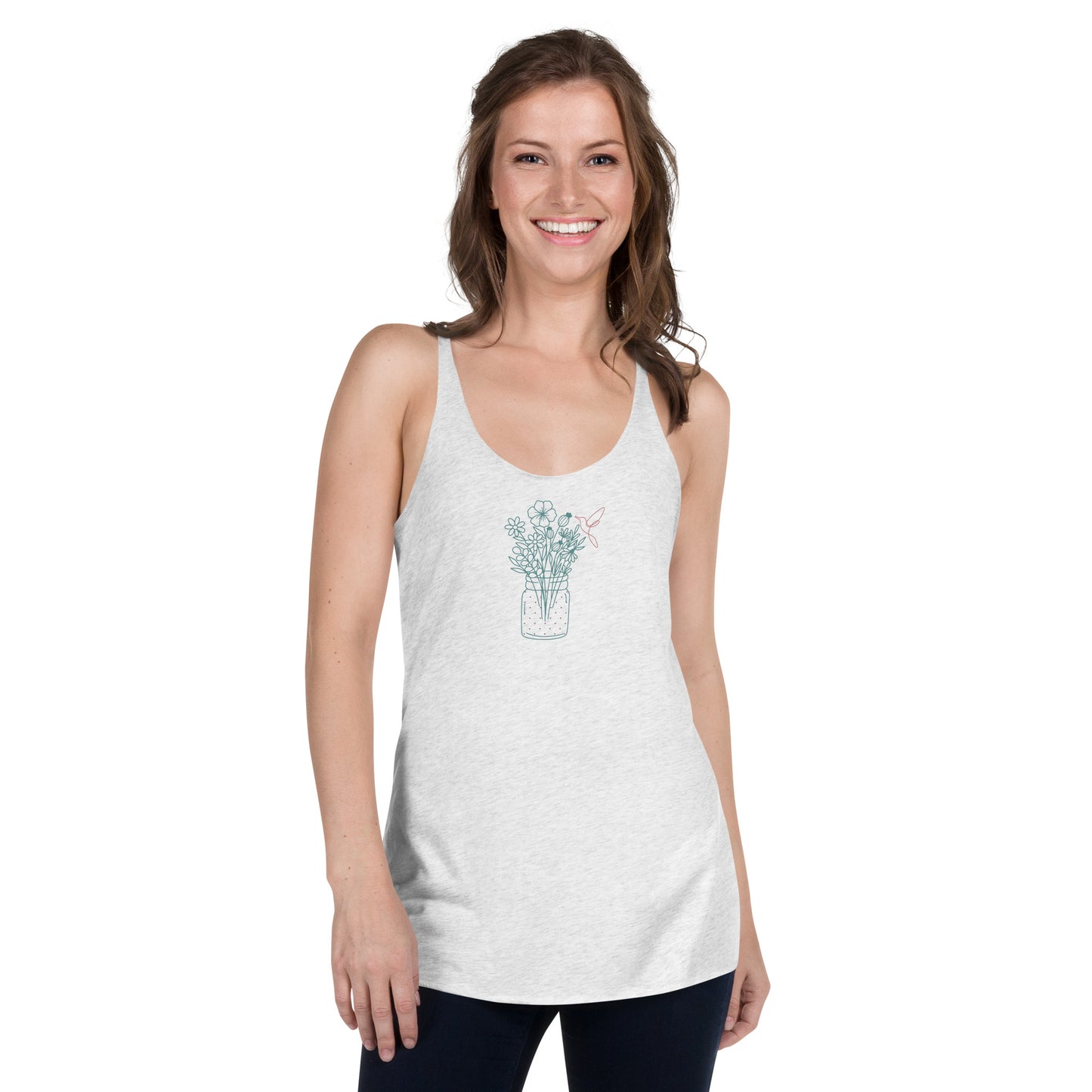 Woman wearing a heather white racer back tank top with a subtle floral arrangement design in a jar.