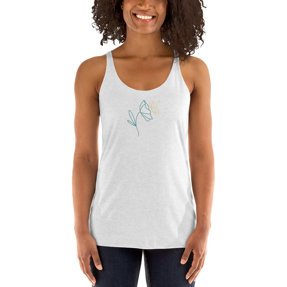 Woman wearing a heather white racer back tank top with a subtle line drawing of flowers.