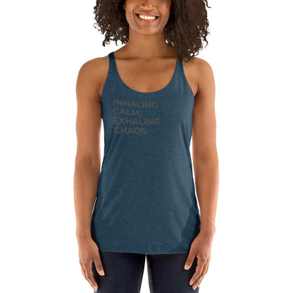 Smiling woman in a indigo racer back tank with "Inhaling Calm, Exhaling Chaos" text.