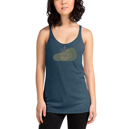 Woman wearing a indigo racer back tank top with a muted coffee cup and floral design.