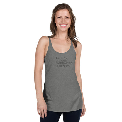 Woman in a premium heather racer back tank with "Letting Go and Embracing Serenity" text.