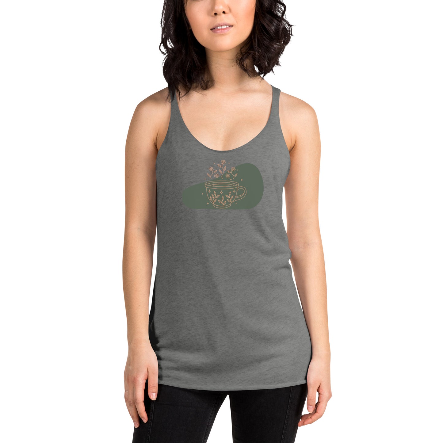 Woman wearing a heather grey racer back tank top with a muted coffee cup and floral design.