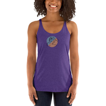 Woman wearing a heather purple racer back tank top with a subtle design of a person gazing at the moon.