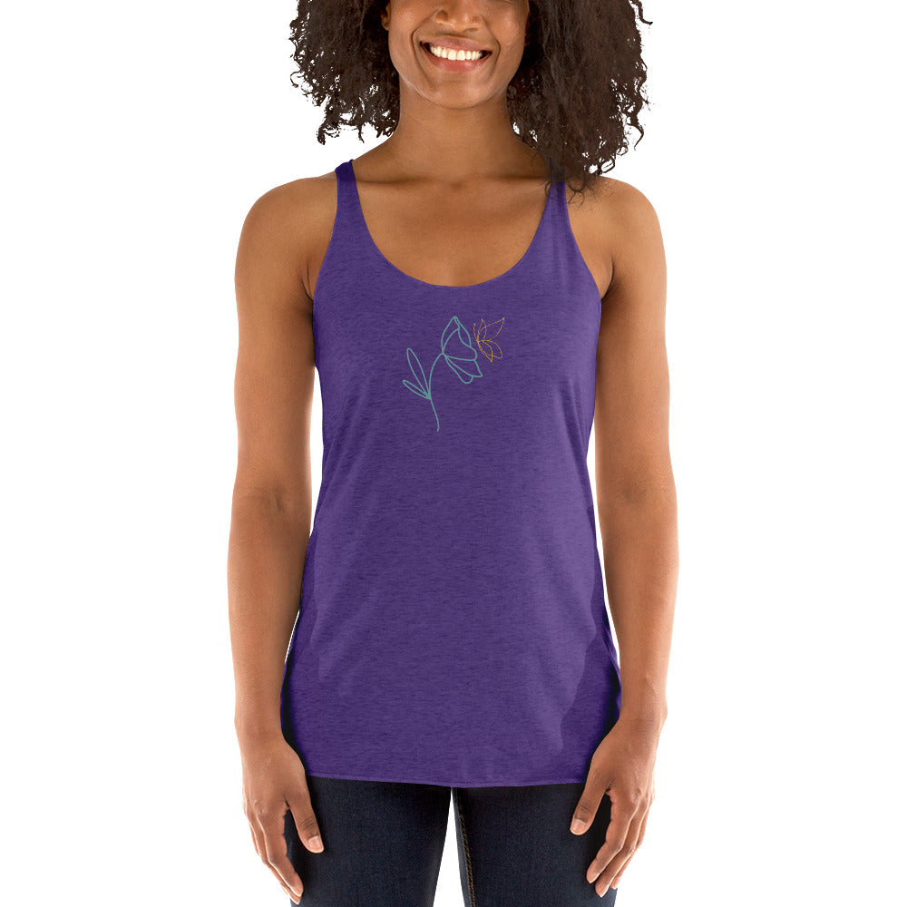 Woman wearing a heather purple racer back tank top with a subtle line drawing of flowers.