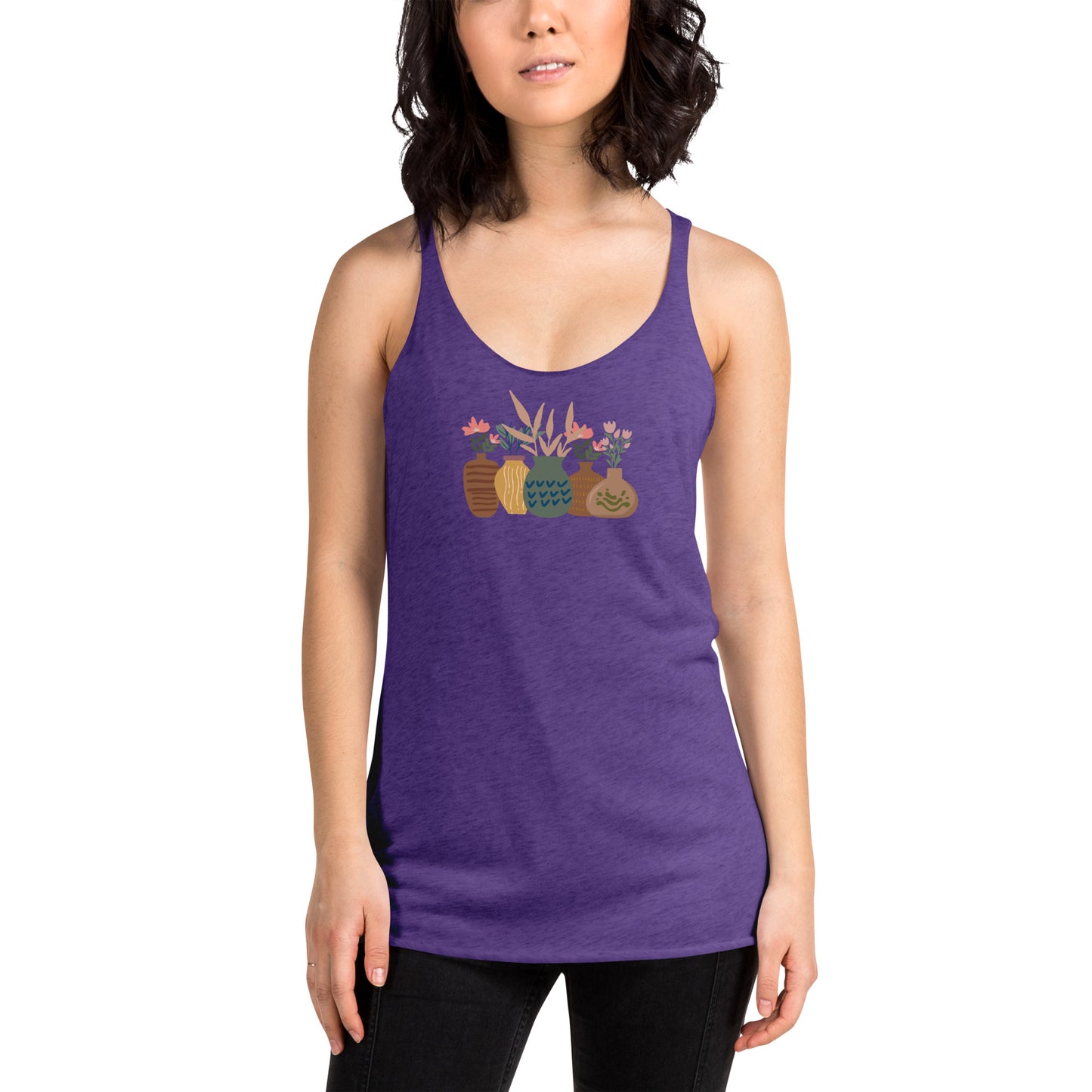 Woman wearing a heather purple racer back tank top with a subtle design of various pots and plants.