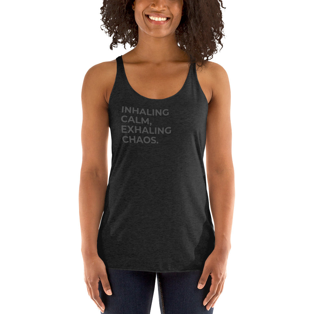 Smiling woman in a vintage dark grey racer back tank with "Inhaling Calm, Exhaling Chaos" text.