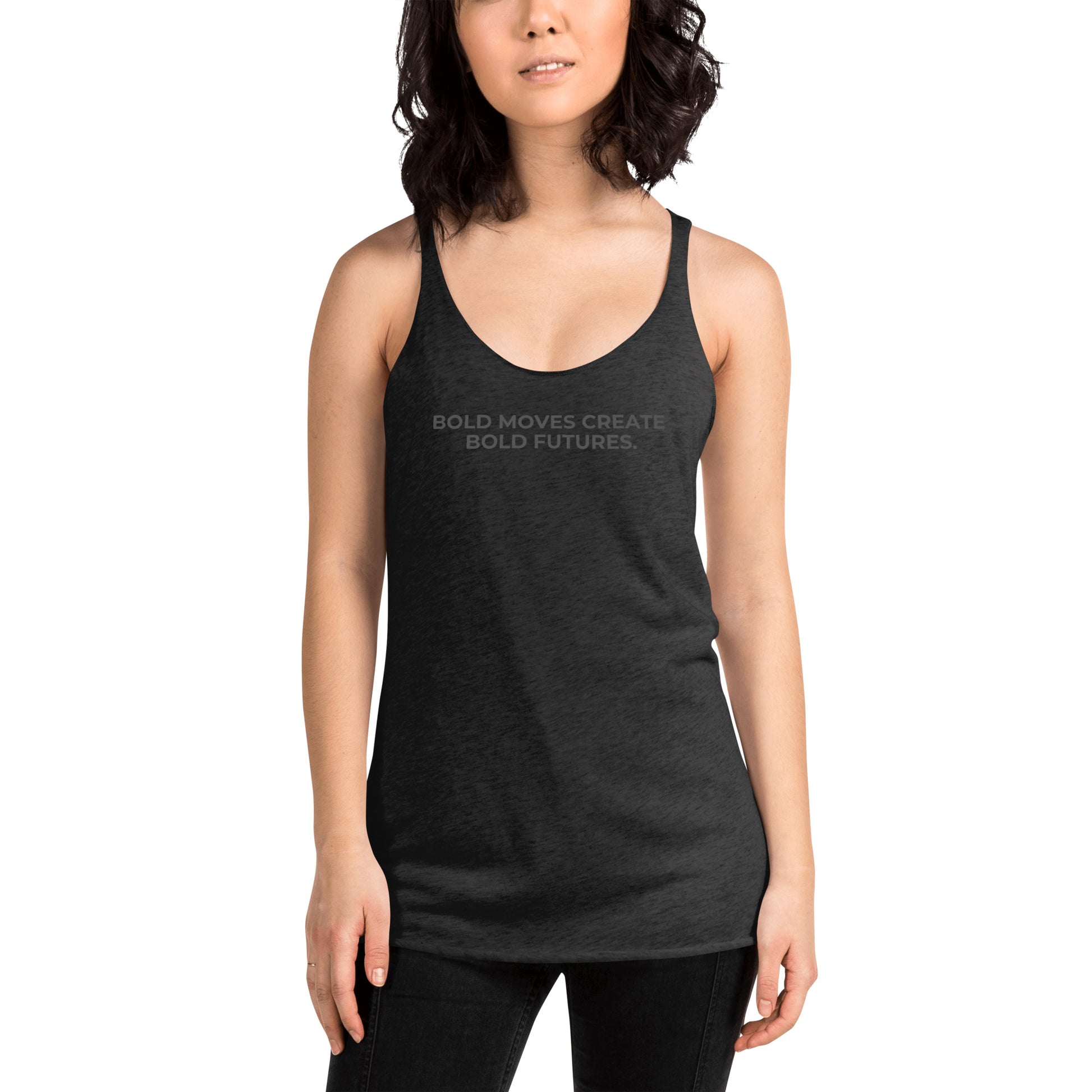 Woman wearing a heather dark grey racer back tank with "Bold Moves Create Bold Futures" text.