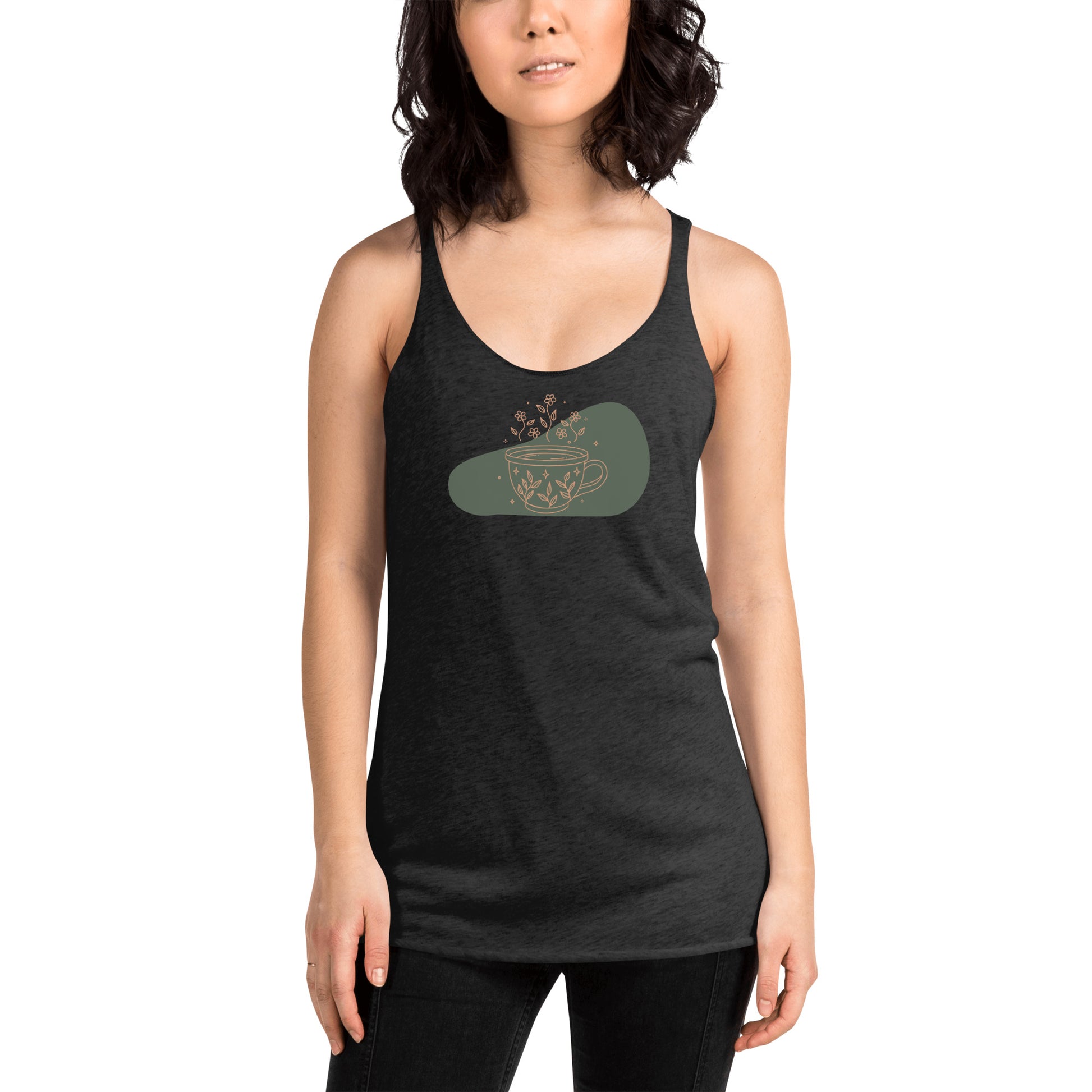 Woman wearing a heather grey racer back tank top with a muted coffee cup and floral design.