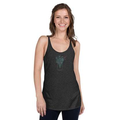 Woman wearing a heather grey racer back tank top with a subtle floral arrangement design in a jar.