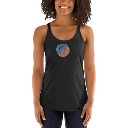 Woman wearing a heather grey racer back tank top with a subtle design of a person gazing at the moon.