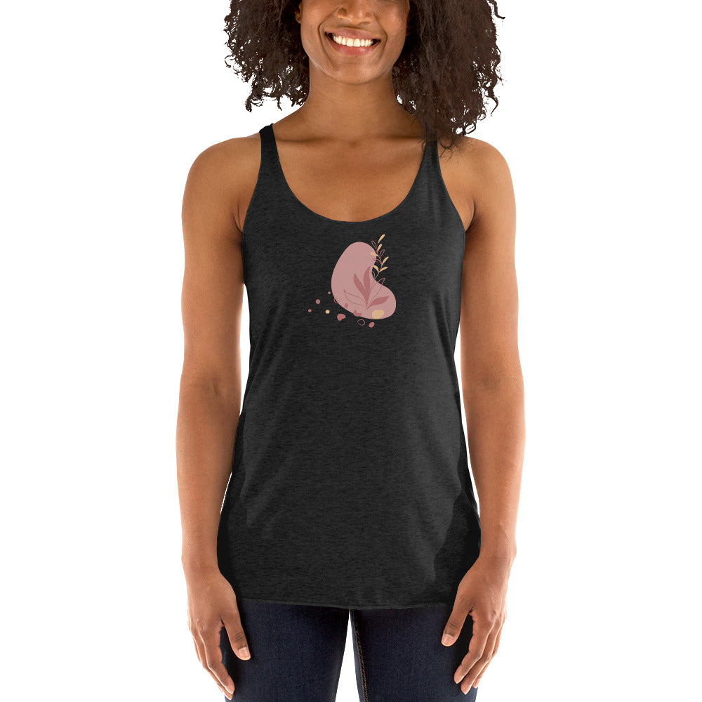 Woman wearing a heather grey racer back tank top with a subtle heart-shaped leaf design. 