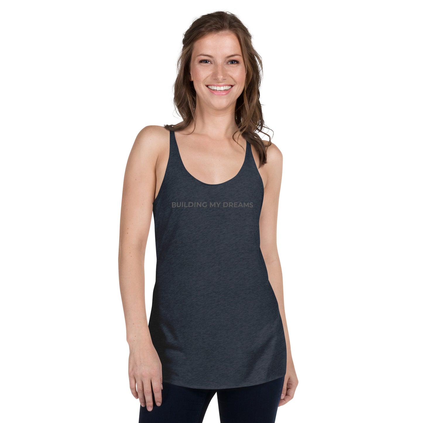 Smiling woman wearing a vintage navy racer back tank with "Building My Dreams" text.