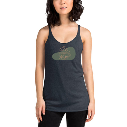 Woman wearing a heather navy racer back tank top with a muted coffee cup and floral design.