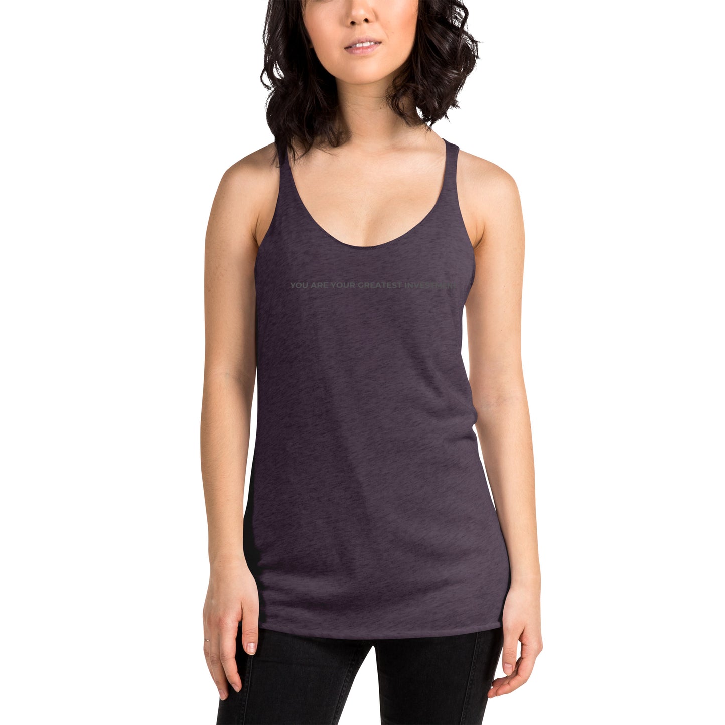 Woman wearing a vintage purple racer back tank with "You Are Your Greatest Investment" text.