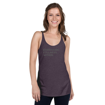 Smiling woman wearing a purple racer back tank with "Embracing Stillness Within" text.