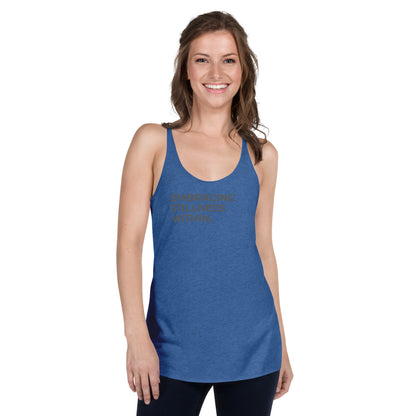 Smiling woman wearing a blue racer back tank with "Embracing Stillness Within" text.